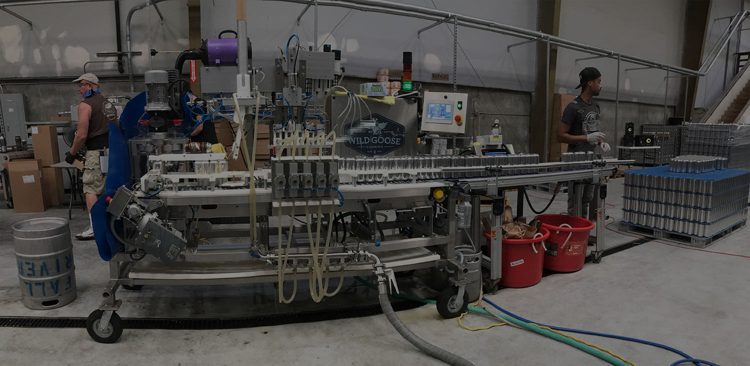 One of our line operators, John, loading cans at Fall River Brewing with a full view of the canning line