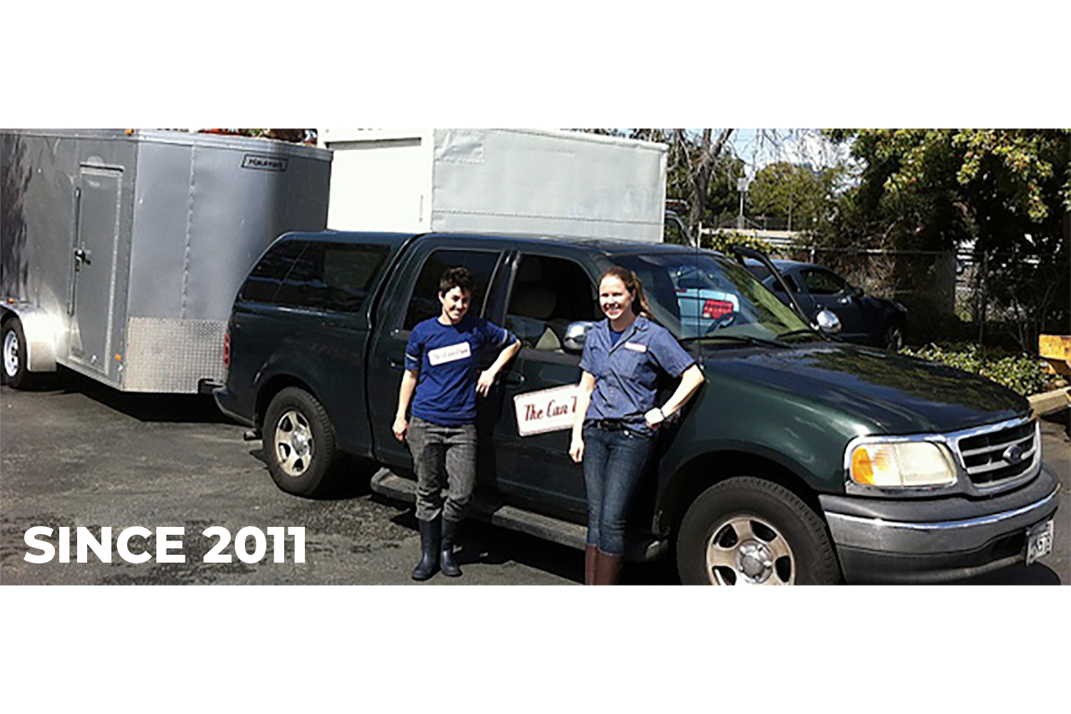 Owners, Jenn and Lindsey, standing in front of their first truck and trailer in 2011