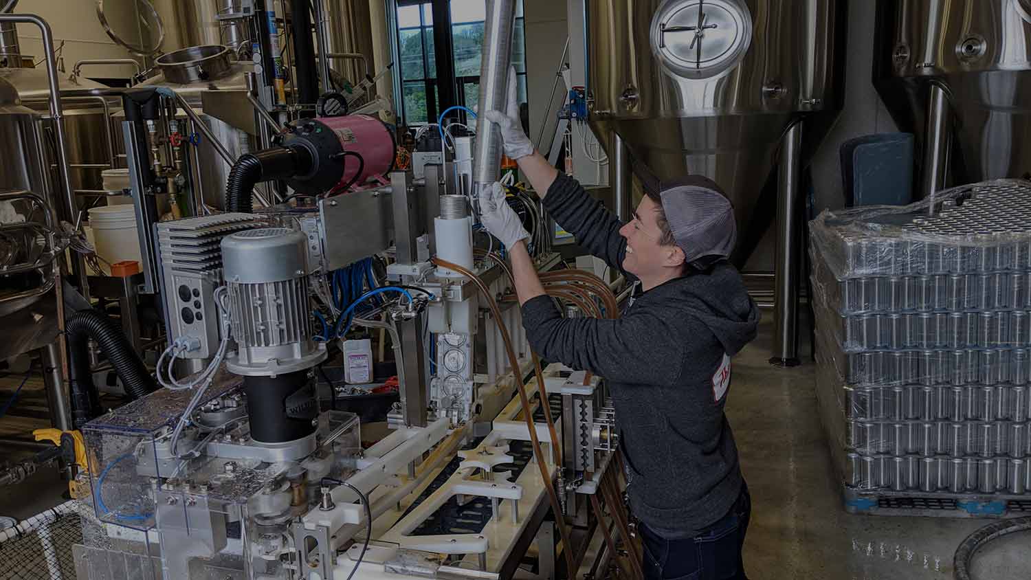 Our co-owner, Lindsey, changing the lid tube on the canning line